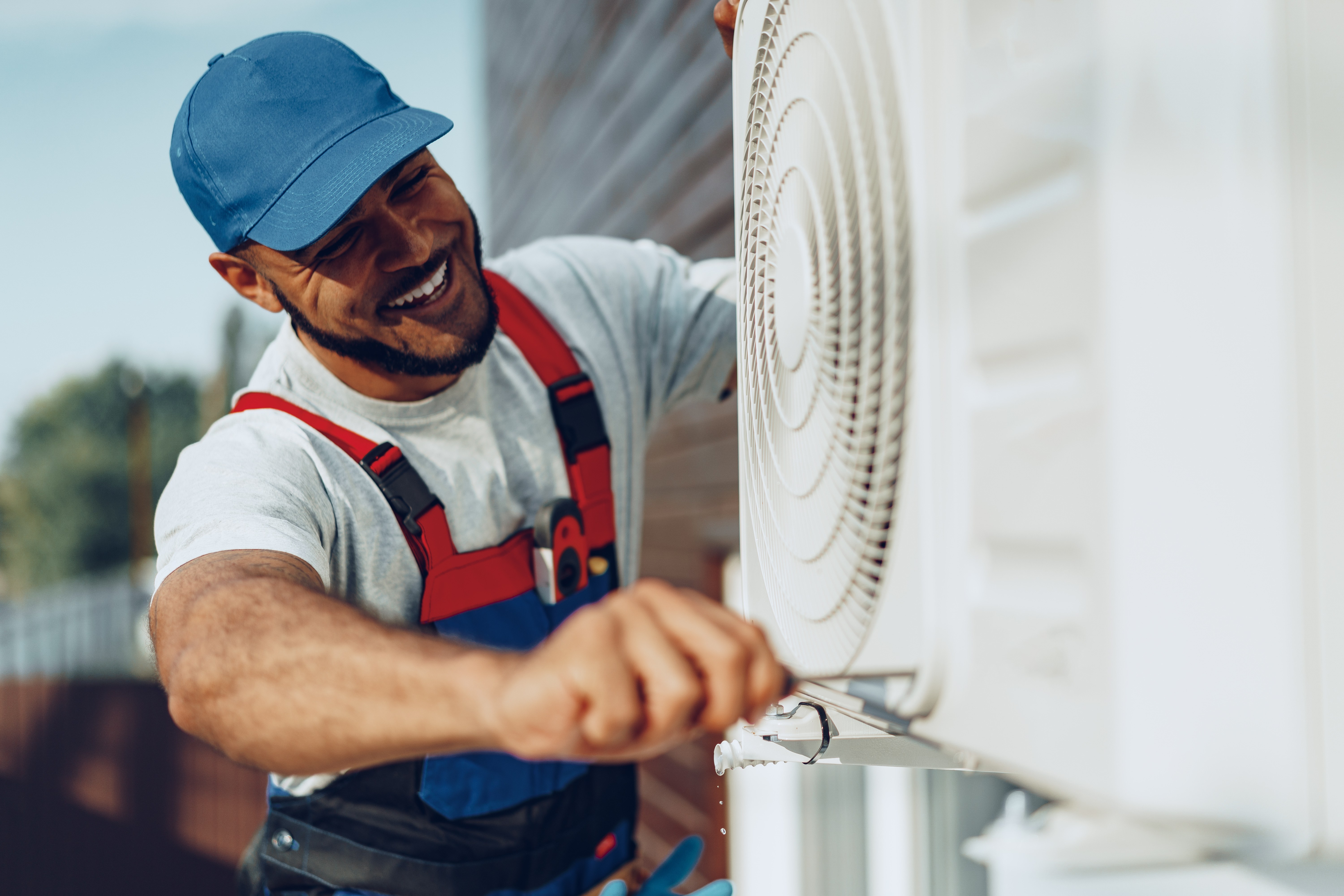 Professional HVAC Technician Installing Air Conditioning System in Los Angeles Home